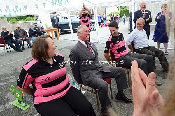 HRH The Prince of Wales competing with members of Llanddewi Brefi Young Farmers Club in a Cockerel race in the marquee at The New Inn 